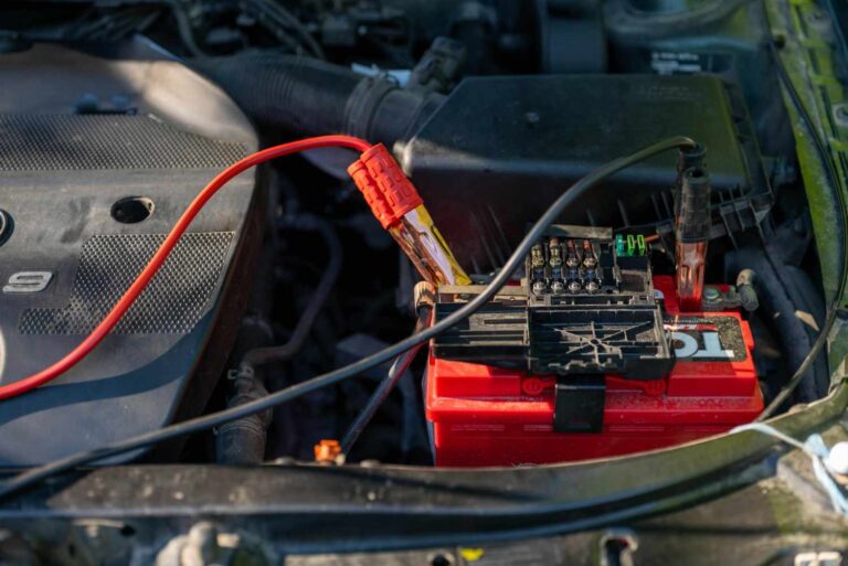A professional battery tester connected to a vehicle battery under the bonnet for mobile car battery replacement services in Sheffield.