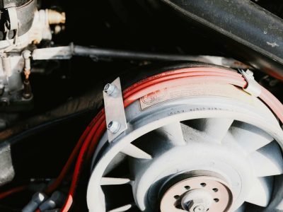 Detailed view of a vehicle electrical wiring loom and fuse box under the bonnet, showing professional car wiring repairs in Sheffield.