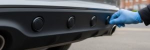 Close-up of professional parking sensors fitted to a car rear bumper by a mobile auto electrician in Sheffield.