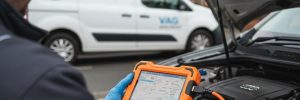 Mobile auto electrician using a professional diagnostic tool on a Volkswagen Audi Group vehicle engine in Sheffield.